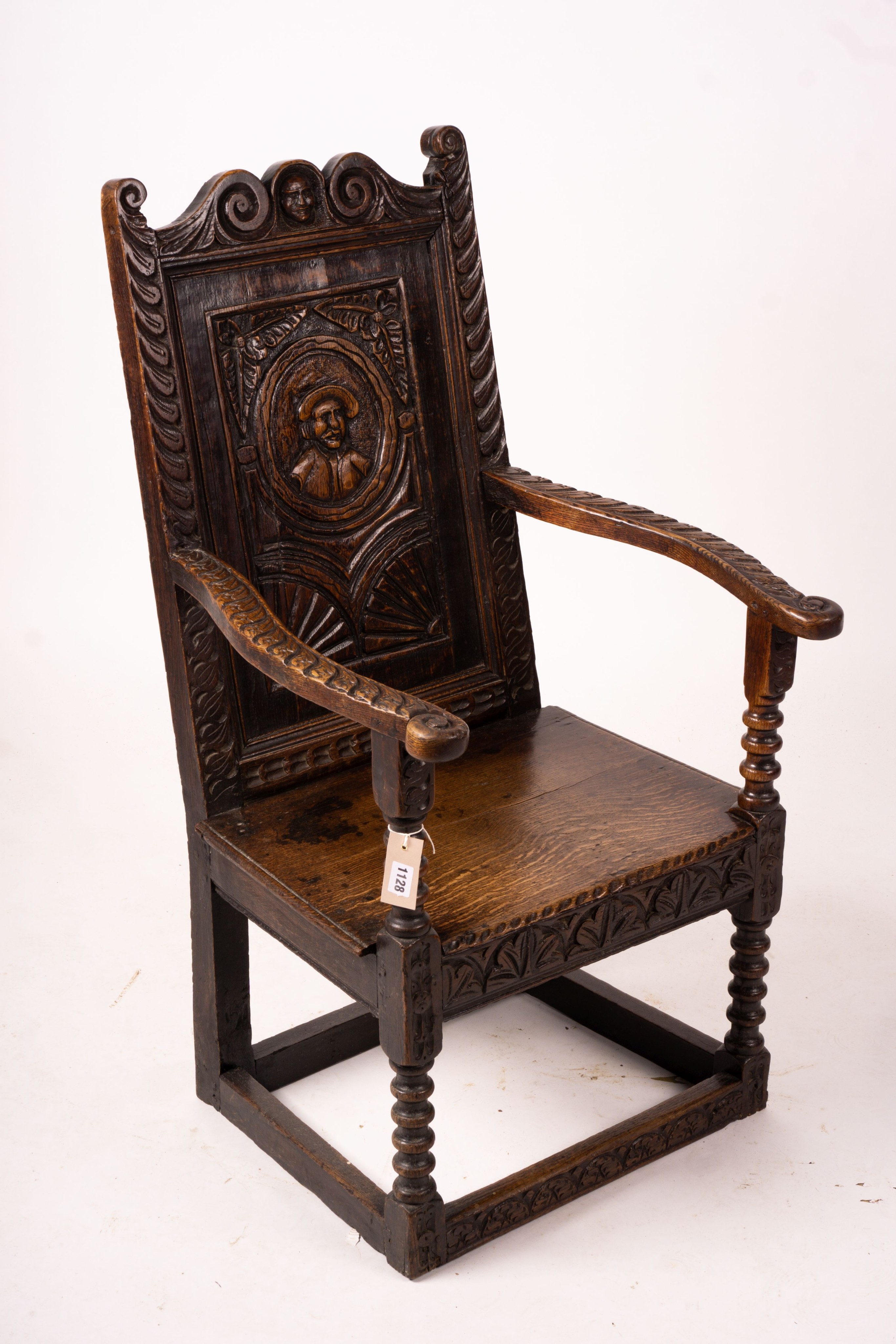 An 18th century style carved oak wainscot chair, width 56cm, depth 60cm, height 101cm